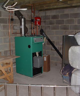 A green biomass boiler in a domestic plant room