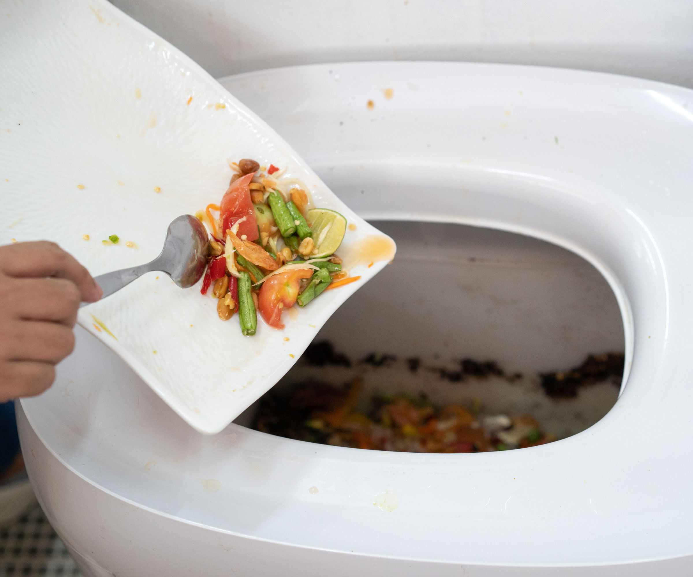 adding waste to electric composting machine