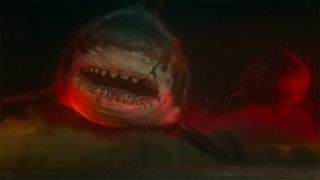 Megalodon underwater with ominous red lighting - Meg 2: The Trench (2023).