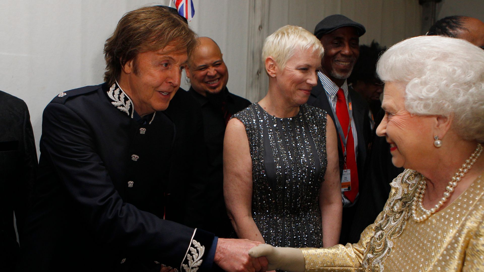 Paul McCartney shaking hands with Queen Elizabeth II