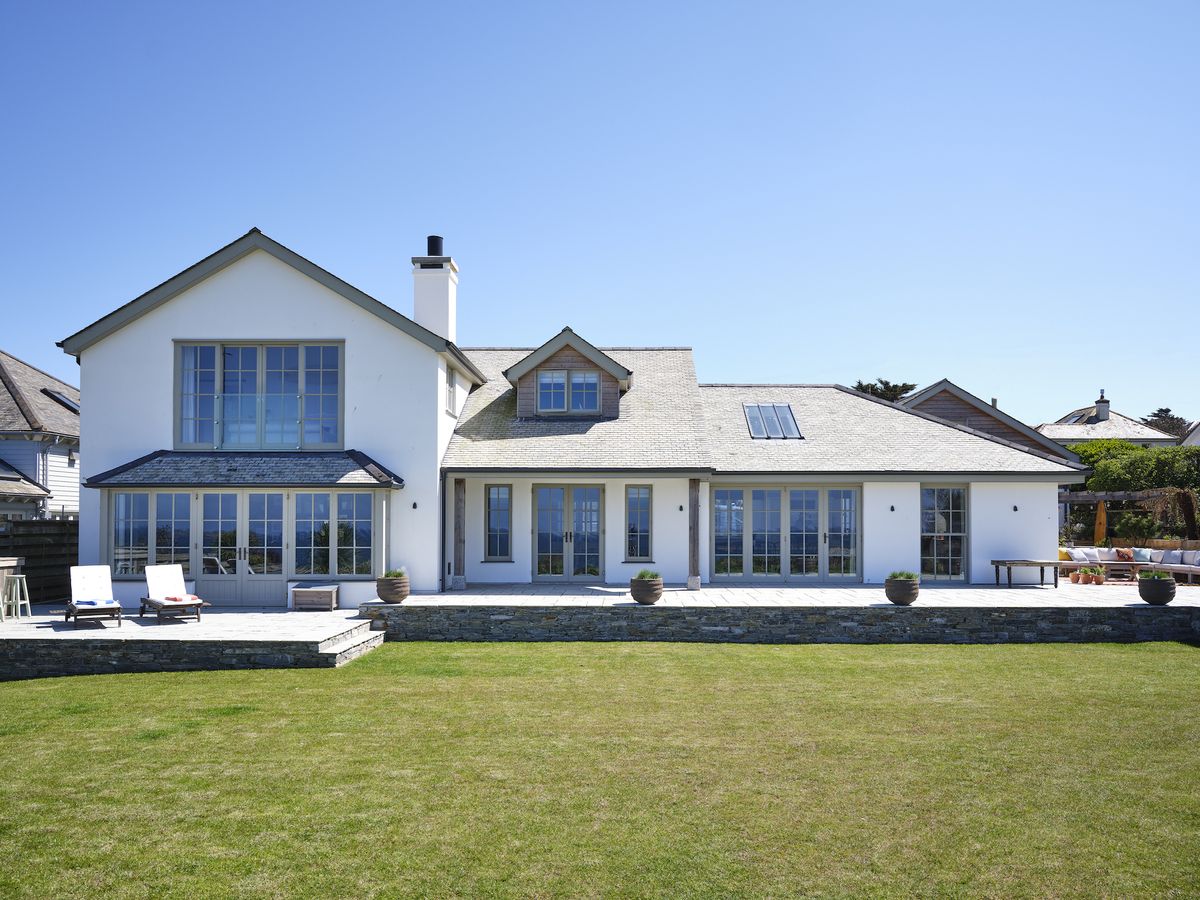 new england style self build with decking and large garden