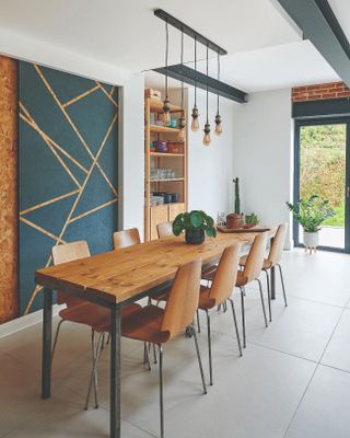 A modern kitchen-diner with a large statement door