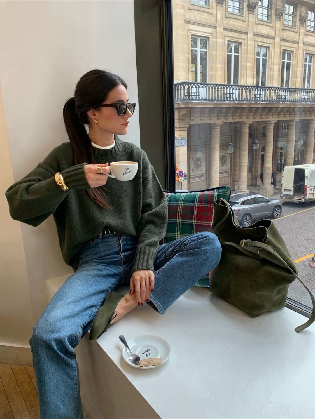 Influencer Leasy in Paris wearing a chunky bangle over jumper sleeves.