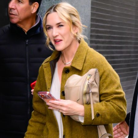 Kate Winslet wears a green coat