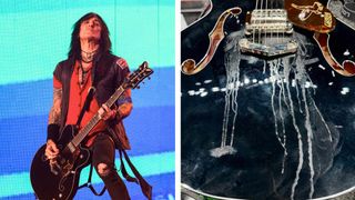 Richard Fortus onstage against a bright blue background, playing his signature Gretsch Falcon