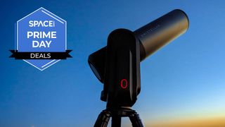 The Unistellar eQuinox 2 smart telescope against a blue and orange sunset with a blue Space.com Prime Day badge in the upper-left corner.