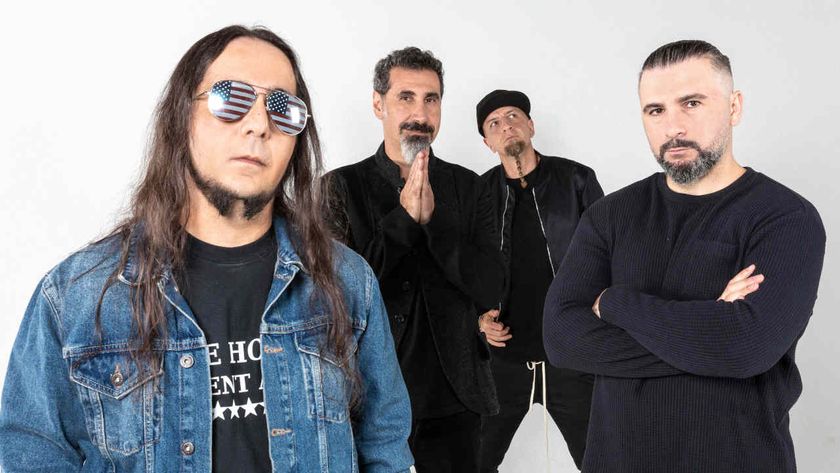 System Of A Down standing against a white wall