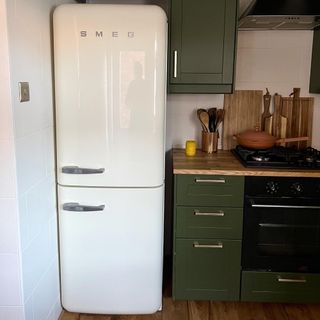 green kitchen with white smeg fridge