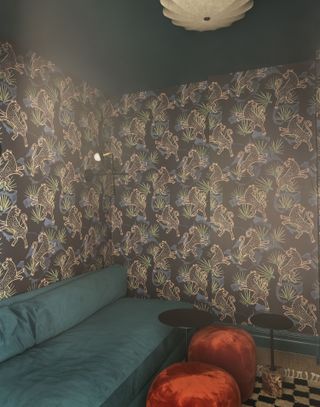 A den area with heavily printed wallpaper