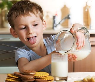 boy with milk and cookies.