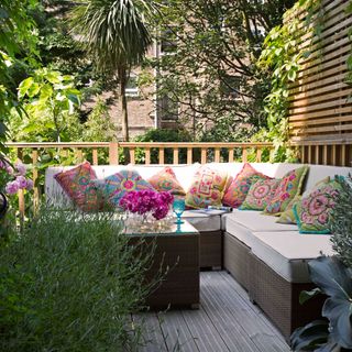 outdoor living area on decking with large sofa and bohemian cushions
