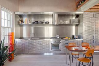 modern kitchen with stainless steel cabinets and a long stainless steel table