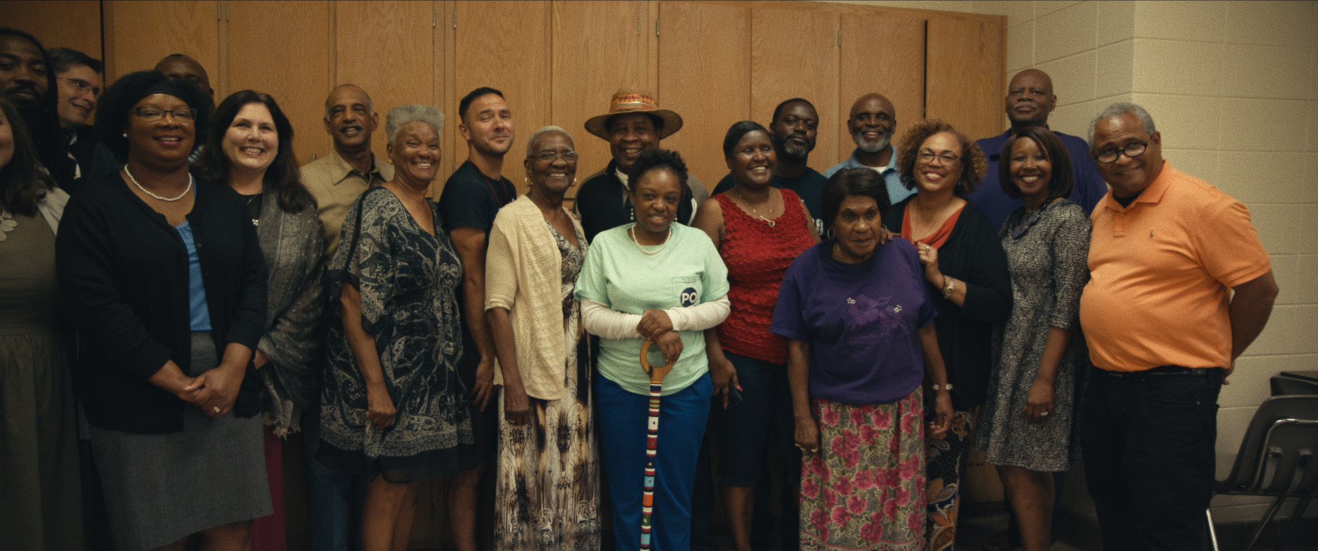 Clotilda descendants and community activists stand in a room in Descendant
