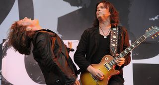 Joey Tempest throws his head back in appreciation as John Norum solos during Europe's performance at Sonisphere 2010.