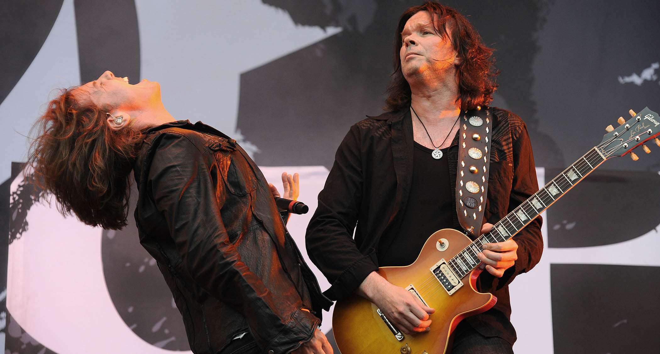 Joey Tempest throws his head back in appreciation as John Norum solos during Europe's performance at Sonisphere 2010.