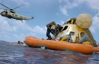 NASA astronaut Alan Bean exits the Apollo 12 command module after splashdown in 1969.