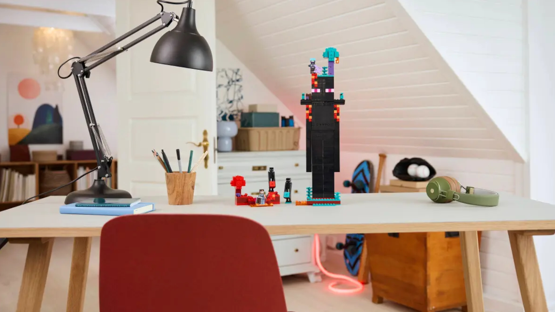 Lego The Enderman Tower on a wooden table with a lamp