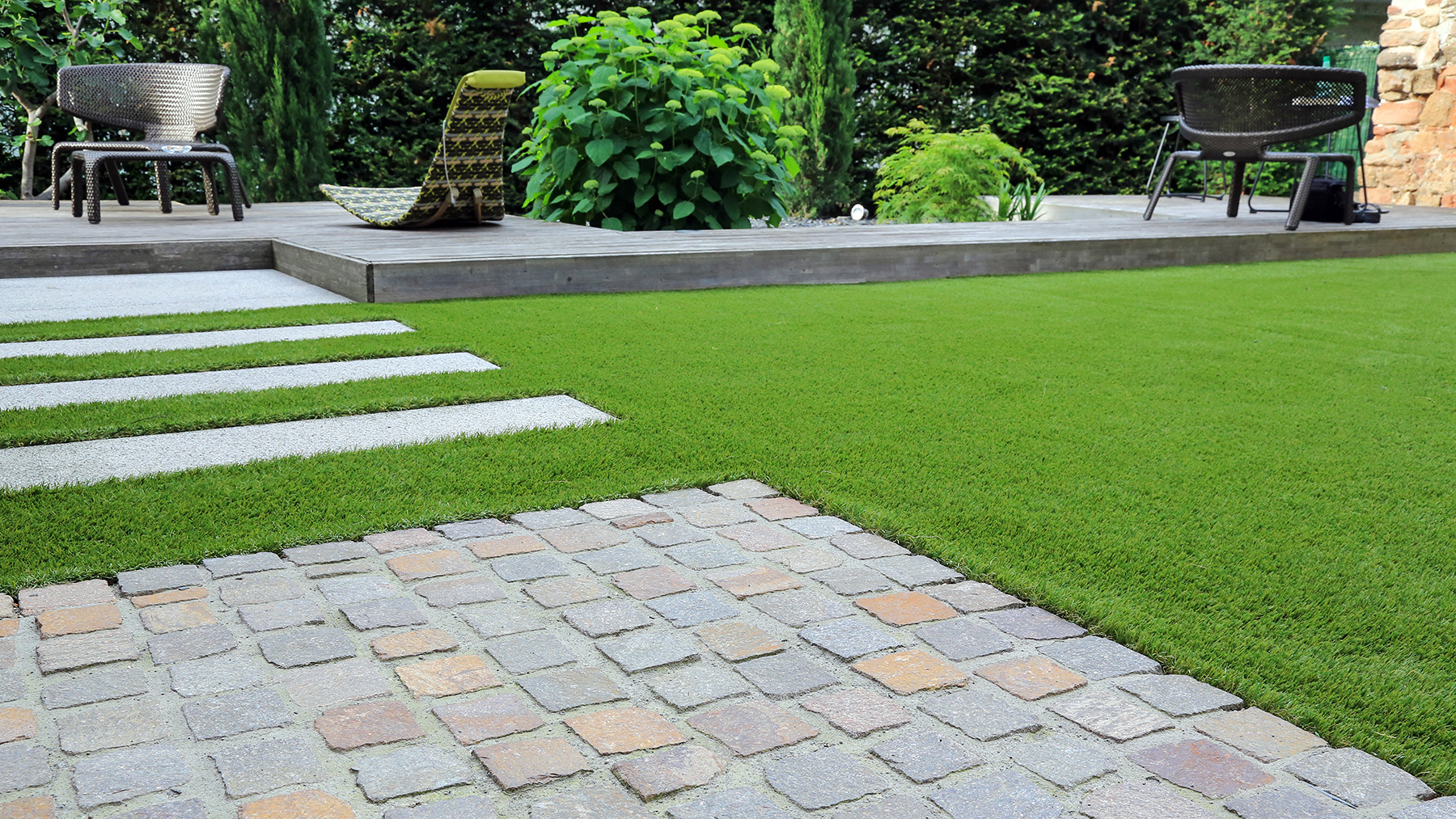 Modern garden design with paving and lawn