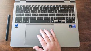 Close up of the Samsung Galaxy Book5 Pro 360 keyboard with my hand on the touchpad.