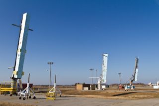 Three rockets that are part of the five rocket ATREX mission stand in launch position during testing at the Wallops Flight Facility. The rockets are placed in a foam box to maintain the temperature of the solid-fueled rocket motors and the payload. These boxes remain around the rockets until launch. At that point, the rocket rips through the foam as it leaves the launcher.