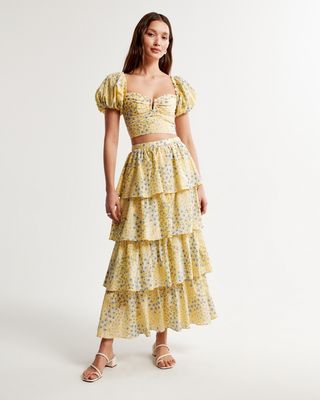 Abercrombie & Fitch model wearing yellow printed crop top and tiered ruffled skirt
