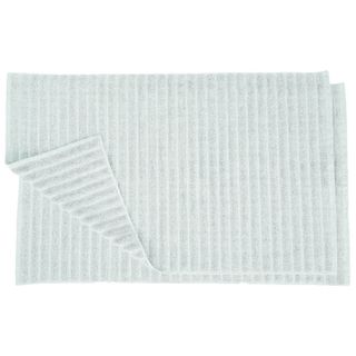 Two light blue cotton bathmats on top of one another. The bottom left corner of the top bathmat flipped over to reveal the one beneath. white background. 