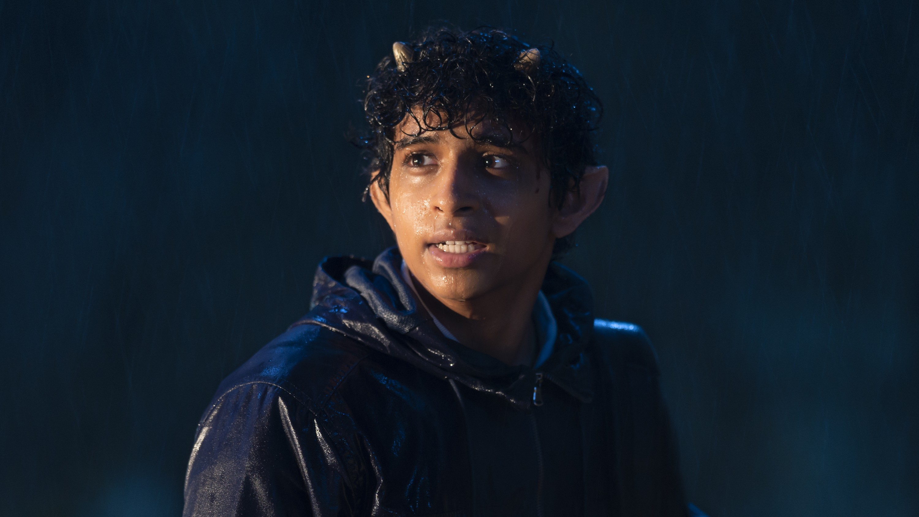 Aryan Simhadri as Grover Underwood in the rain in Percy Jackson & The Olympians