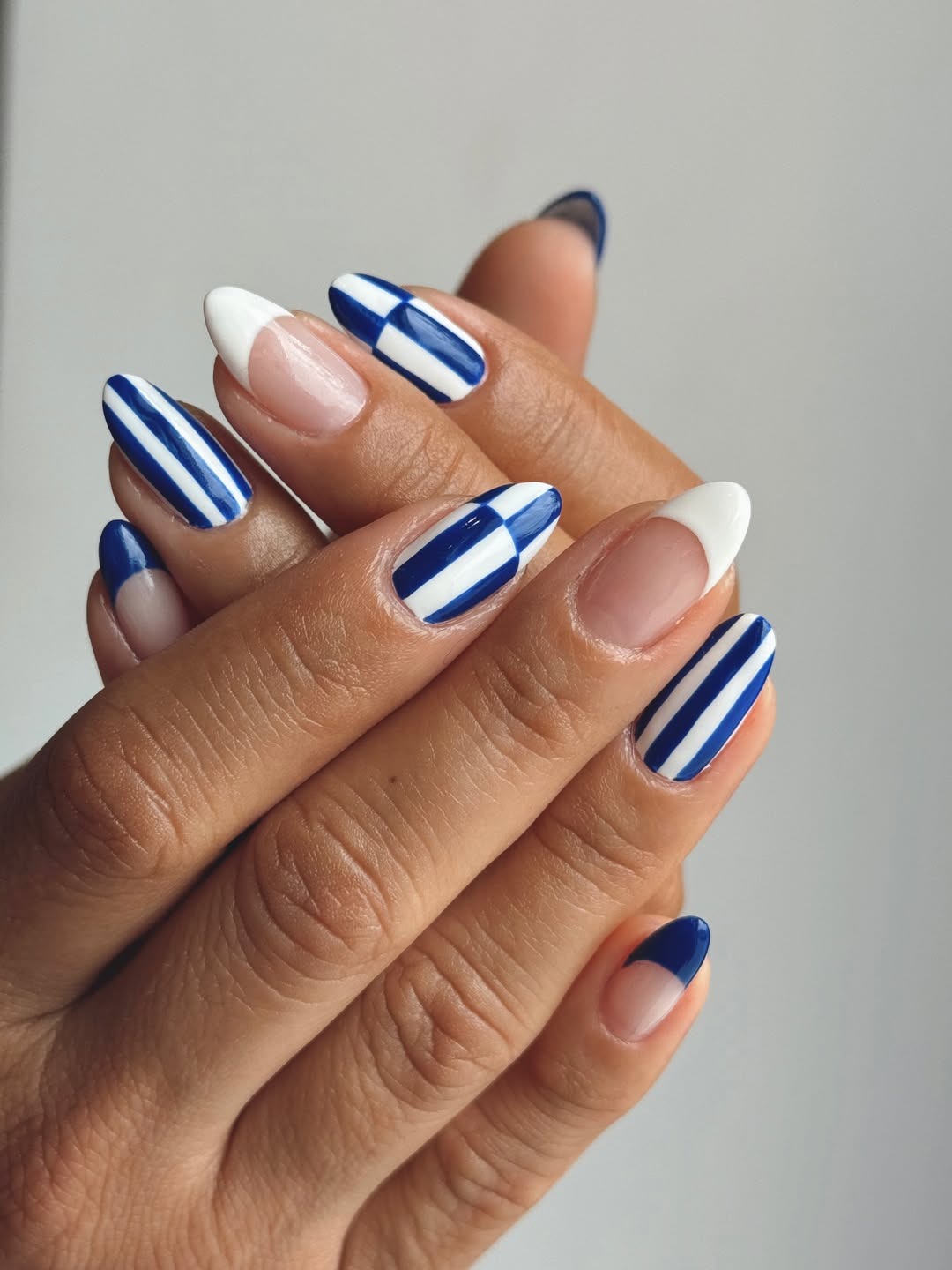 A blue and white stripe nail art design