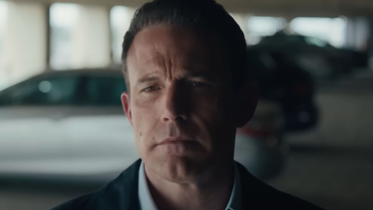 Ben Affleck stands in a parking garage with a neutral expression in The Accountant 2.