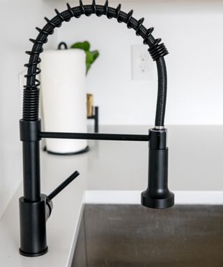 A kitchen sink with a tap