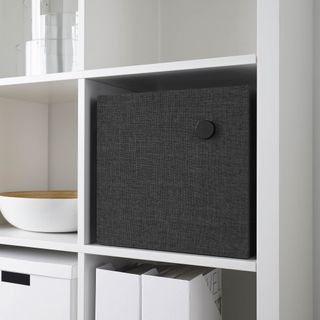Bluetooth speaker slotted into storage unit in living room