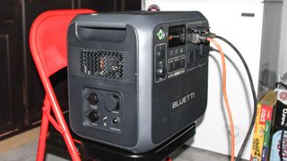 The Bluetti AC200L powering a chest freezer with an extension cord plugged in