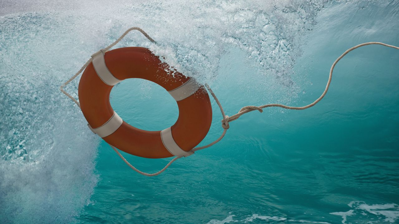 A life ring is submerged under water.