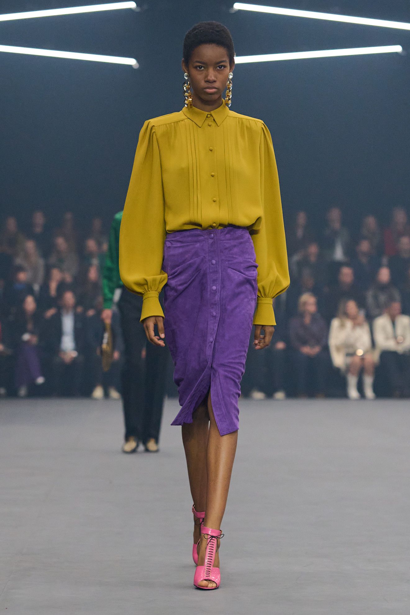 Model wears a purple pencil skirt with a mustard blouse and pink heels on the Valentino spring/summer 2026 runway.