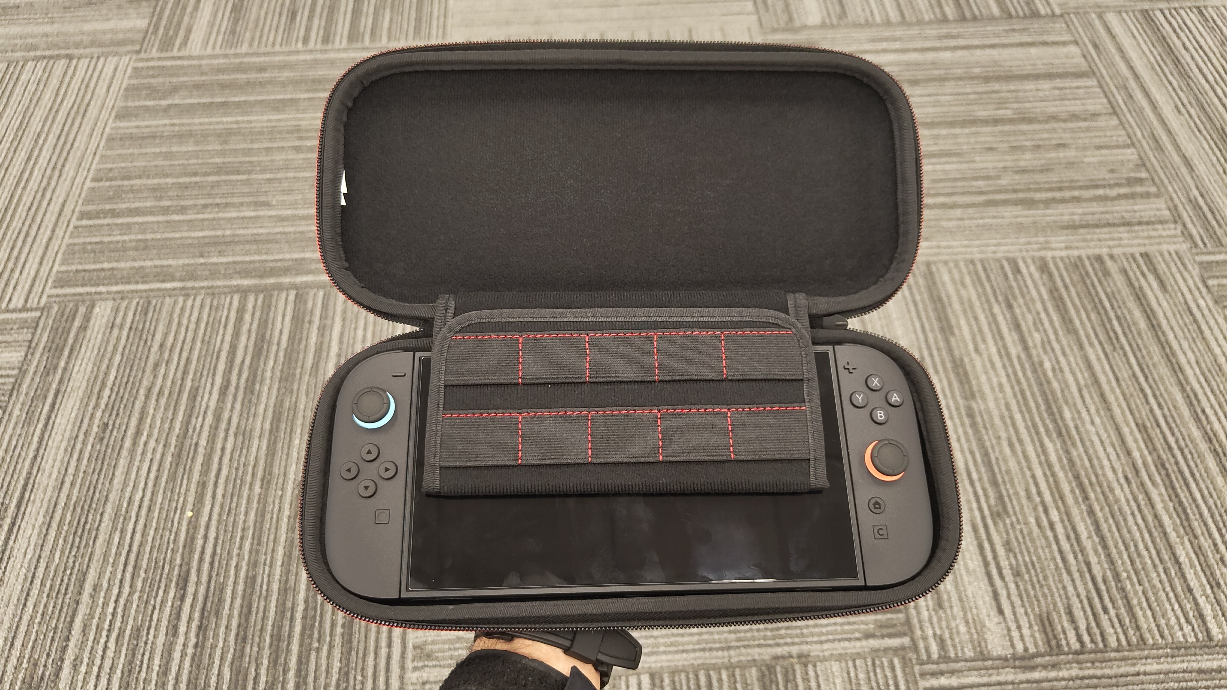 A Switch 2 console in hand inside the PowerA Slim Case for Nintendo Switch 2