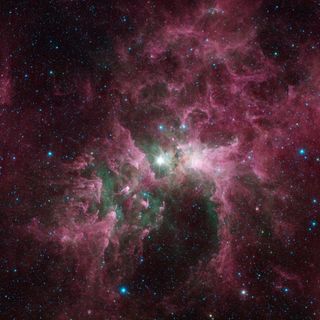 This new view shows the Carina nebula seen by NASA's Spitzer Space Telescope. The bright star at the center of the nebula is Eta Carinae, one of the most massive stars in the galaxy. Its blinding glare is sculpting and destroying the surrounding nebula. Image released Aug. 23, 2013.