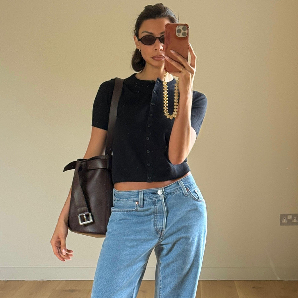 Woman in a black knit top and jeans