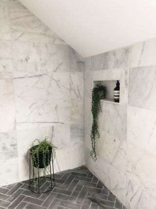 shower storage ideas wall niche in marble bathroom with grey parquet floor tiles