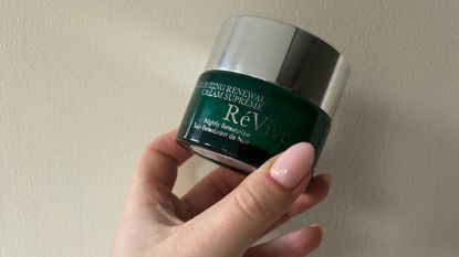 Tori holding RéVive Moisturizing Renewal Cream Supreme