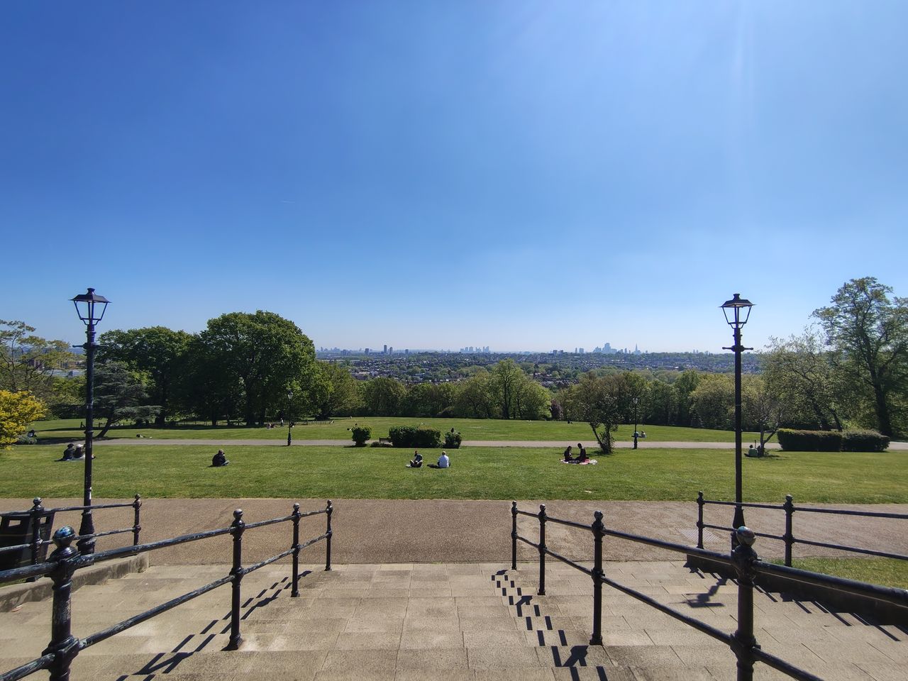 A camera sample taken on the Motorola Edge 70 Fusion, showing a park and distant city-scape.