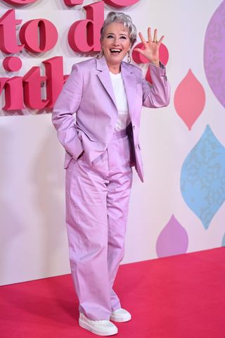 Emma Thompson wearing a purple suit on the red carpet