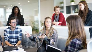 Employees sat around together discussing business issues