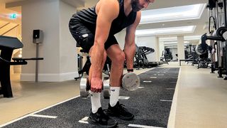 Calum Sharma, personal trainer at the Body Lab, performs the start position of a bent over row