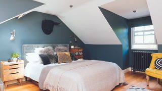 green bedroom with dormer windows in loft conversion