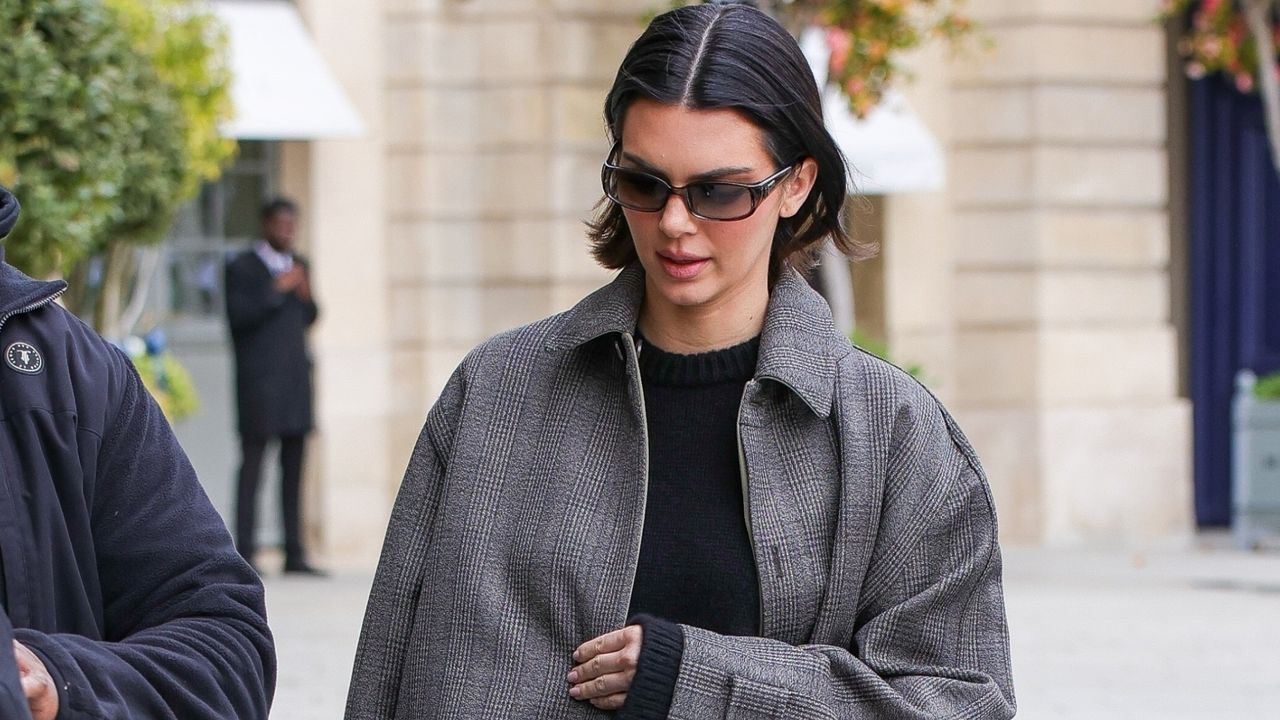 Kendall Jenner wears a gray coat and jeans with ballet flats while walking in Paris