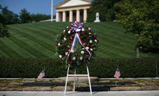 A wreath stands in front of the gravesite of President Kennedy at Arlington National Cemetery in 2012.