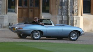 Britain's Prince Harry, Duke of Sussex, and Meghan Markle, Duchess of Sussex, leave Windsor Castle in Windsor on May 19, 2018 in an E-Type Jaguar after their wedding to attend an evening reception at Frogmore House. (Photo by Steve Parsons / POOL / AFP) (Photo credit should read STEVE PARSONS/AFP via Getty Images)