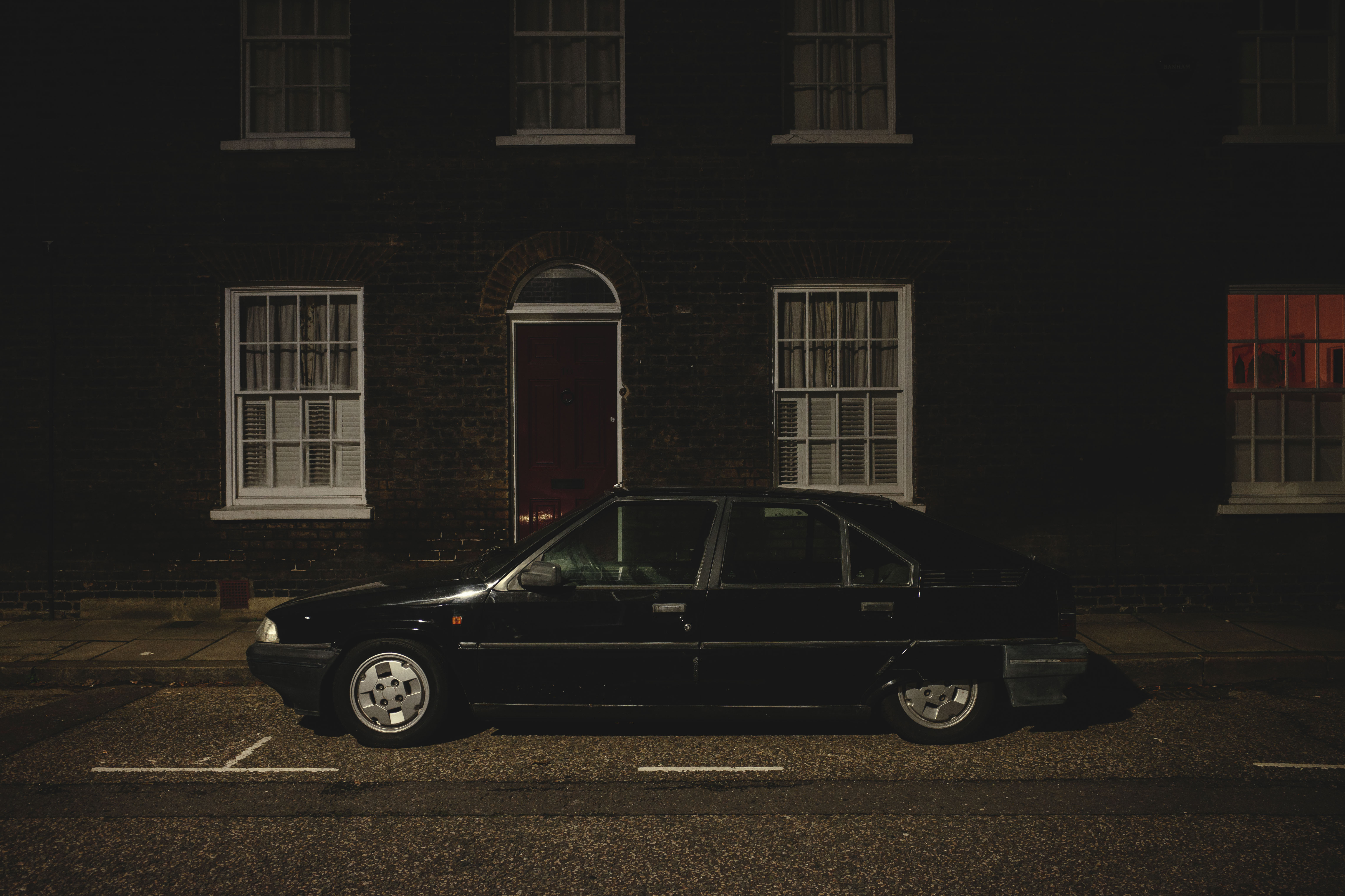 Ricoh GR IV sample images - classic car parked up in front of victorian houses in London at night