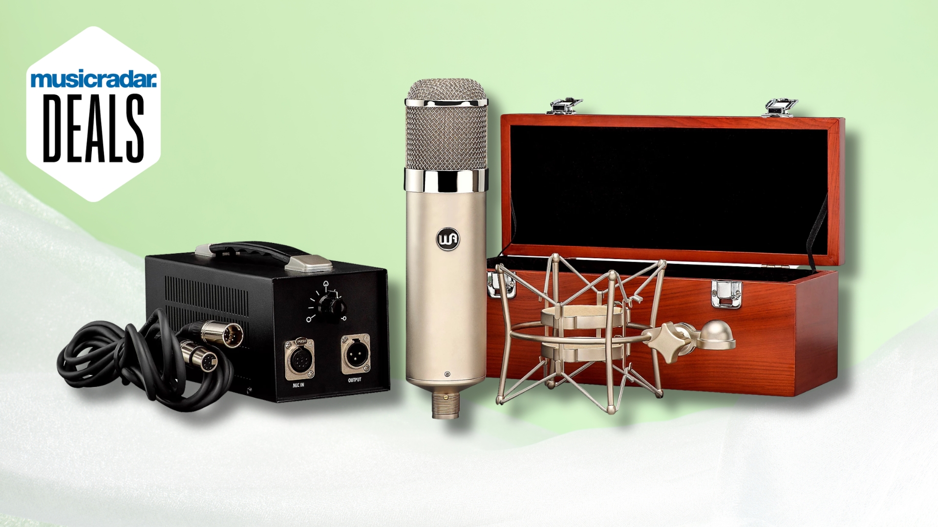 A Warm Audio WA-47 tube microphone with power supply, shock mount, and case on a light green and white background