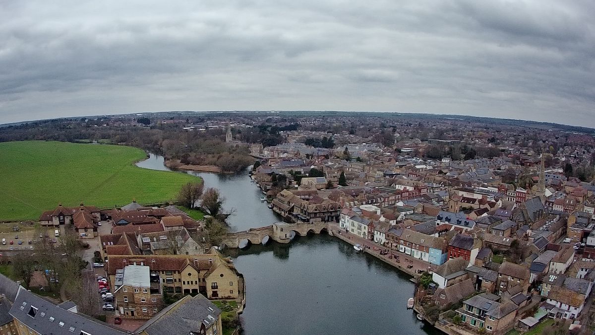 Ruko F11GIM2 Drone Example Image - aerial view of town, old bridge, and river.